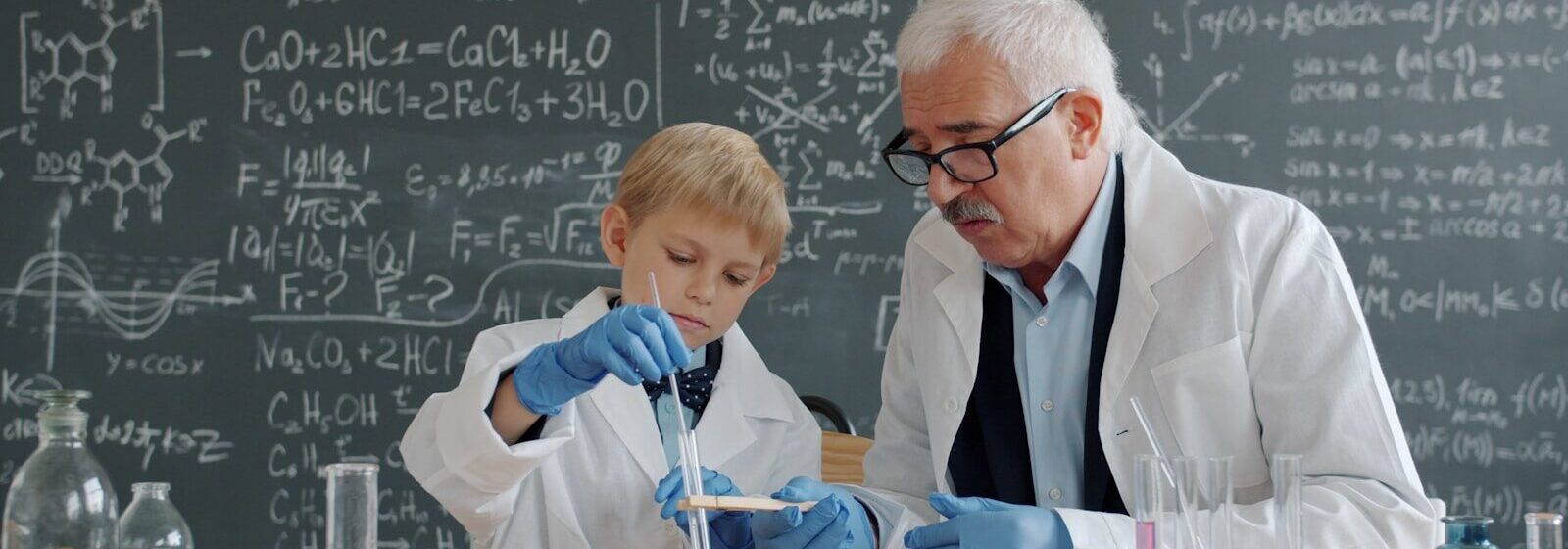 Teacher and student conducting science experiment in classroom.