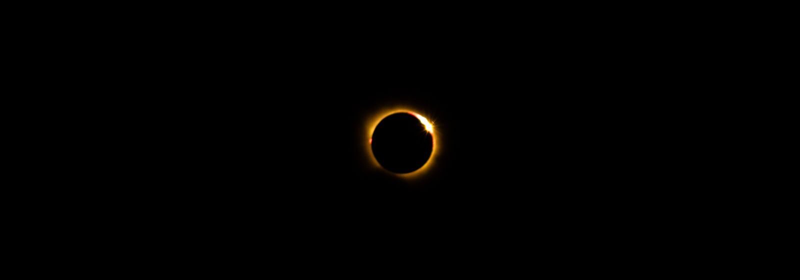 A mesmerizing view of a solar eclipse showcasing the glowing corona against a dark sky.